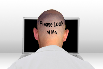 bald doctor facing laptop with "please look at me" on the back of his head