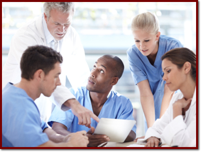 doctors and interns sitting at a table questioning something on paper
